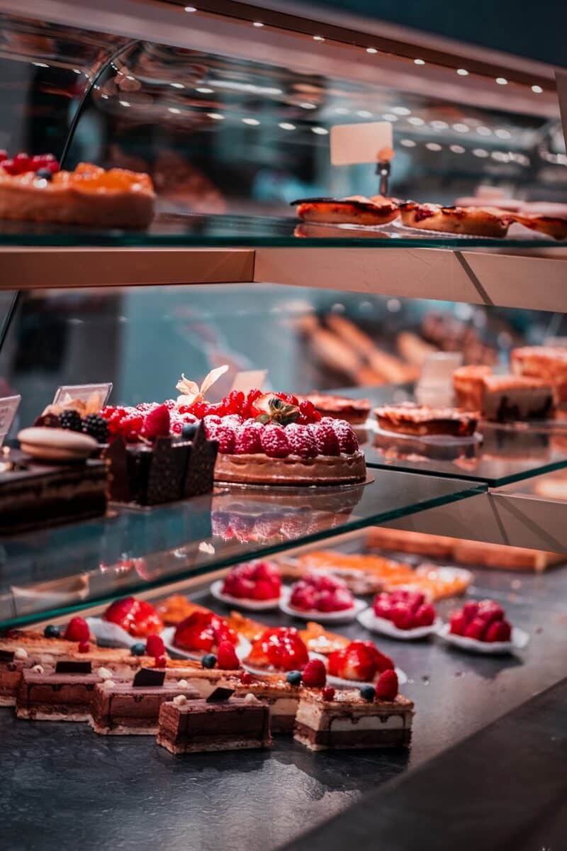 strawberry and blackberry on clear glass display counter