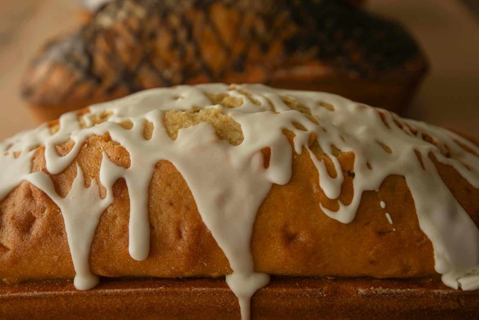 Delicious vanilla pound cake with a creamy white glaze drizzled on top.