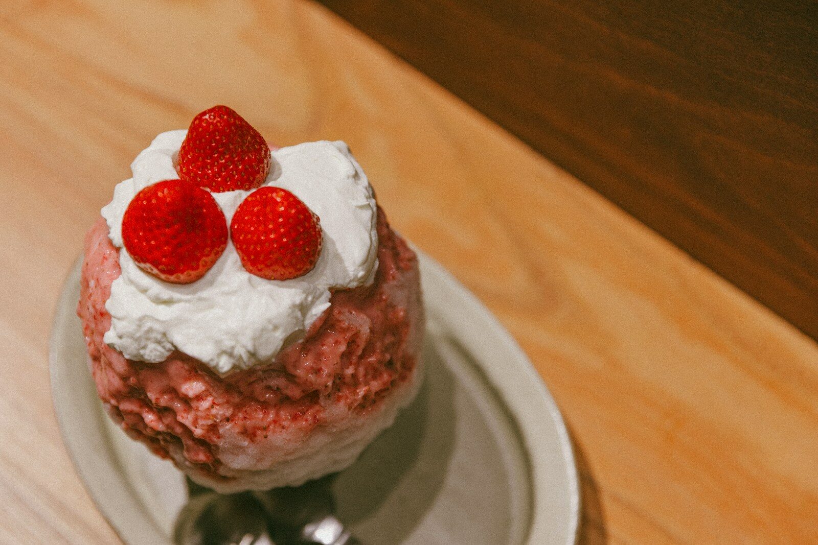 Strawberry shaved ice dessert with whipped cream and fresh strawberries