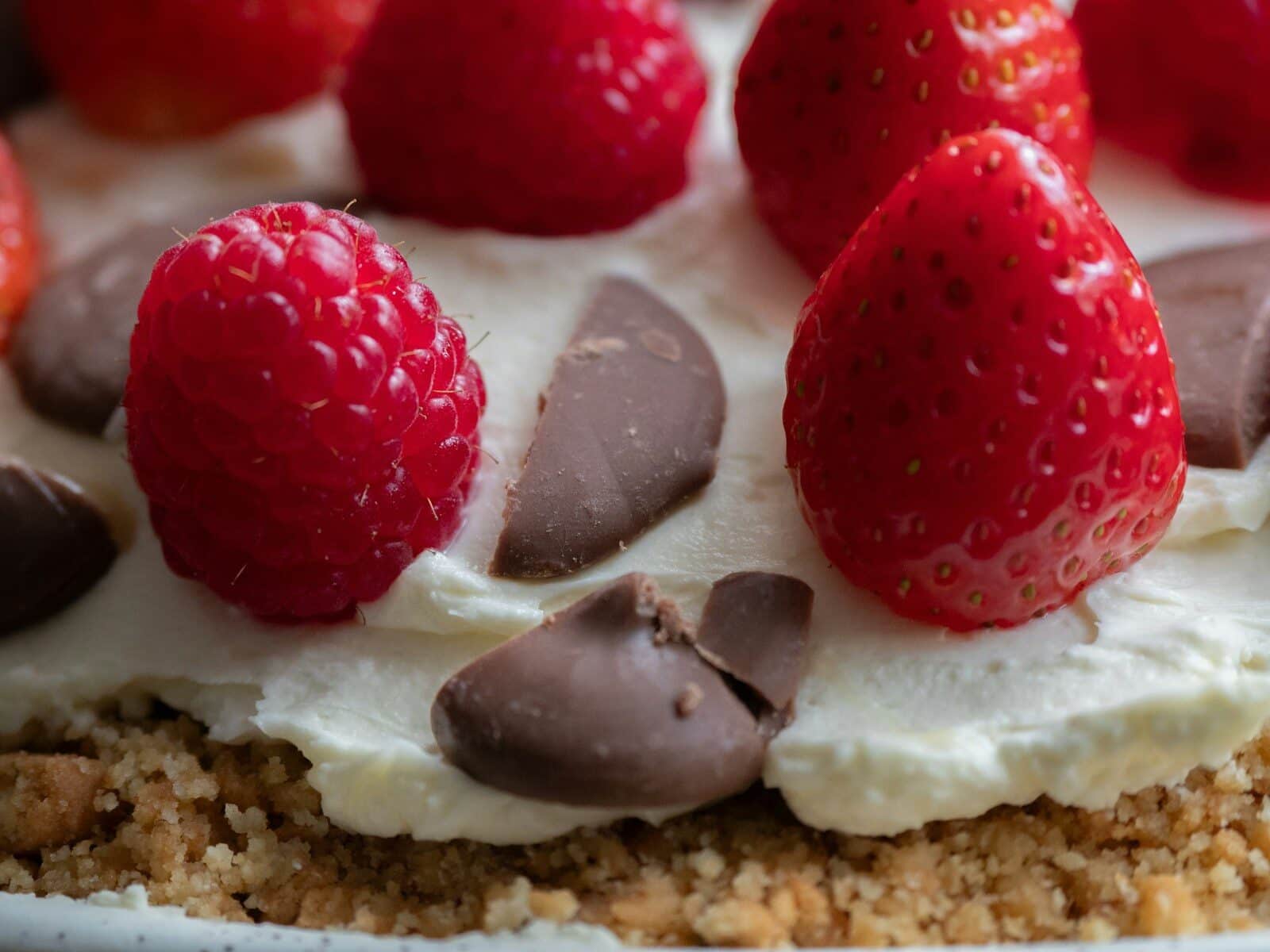 A close up of a cake with strawberries on top