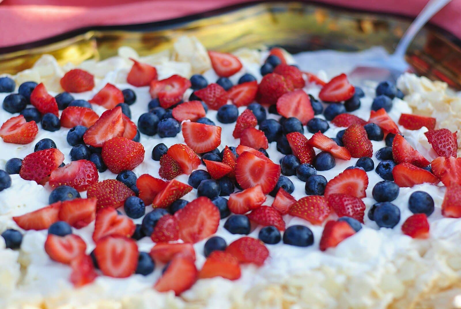 A delicious dessert with berries and whipped cream.