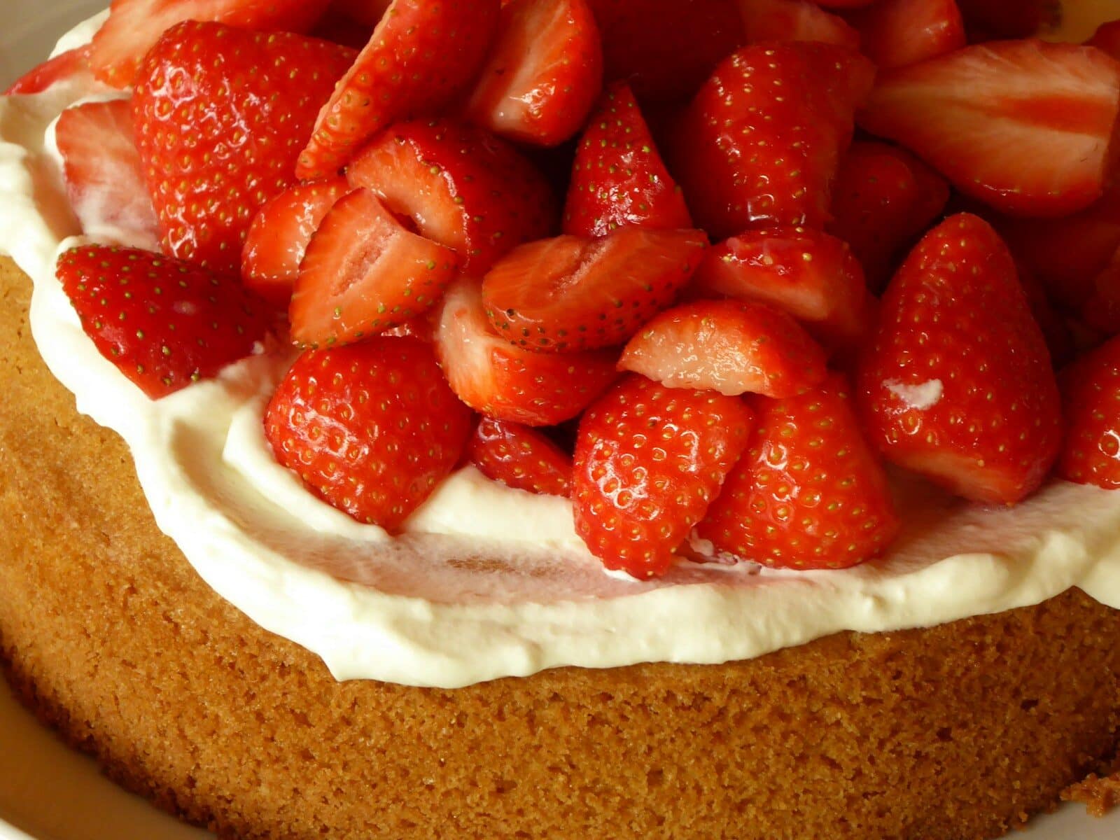 a close up of a cake with strawberries on strawberry honey bun cake